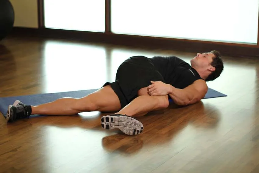 Supine knee twist: start and finish positions
