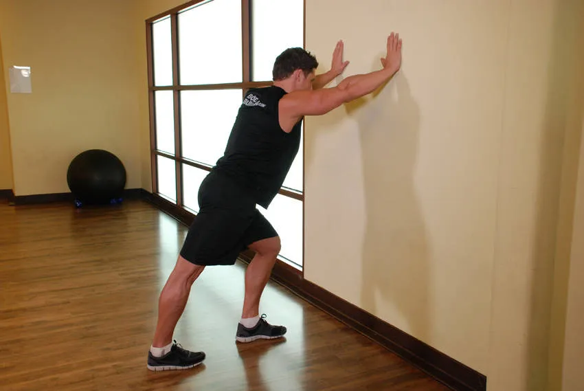 Wall calf stretch: start and finish positions